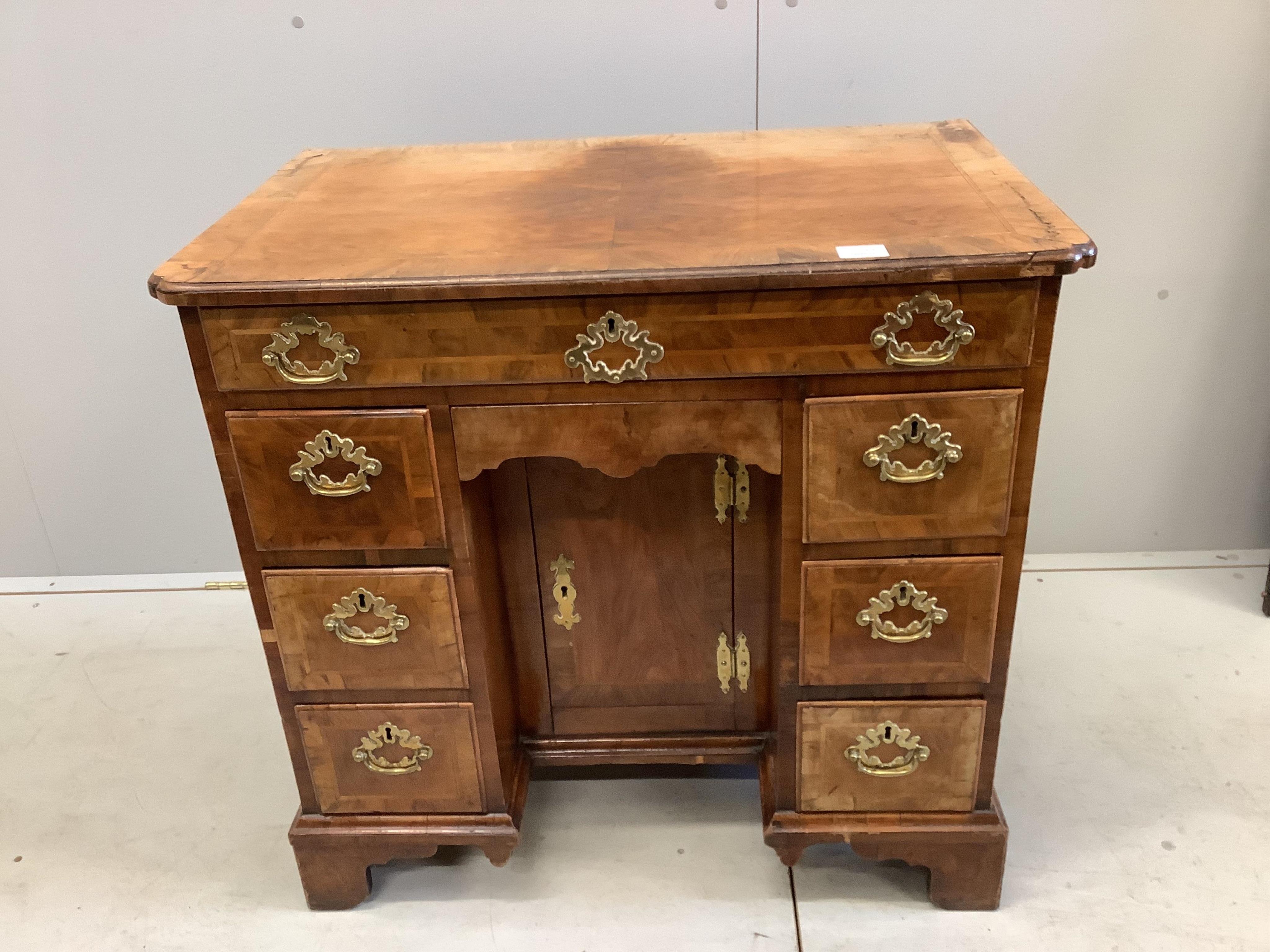 A mid 18th century walnut kneehole desk, width 82cm, height 78cm. Condition - fair to good albeit a little faded on the top